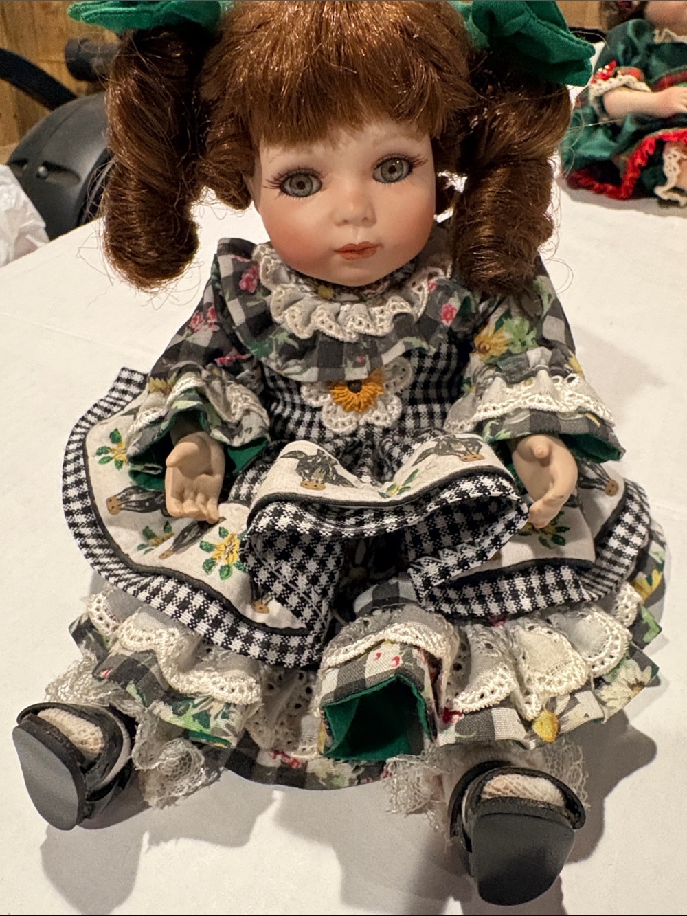 Porcelain Doll in Green and Black Floral Dress